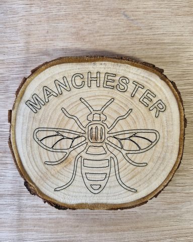 Wooden slice with Manchester Bee
